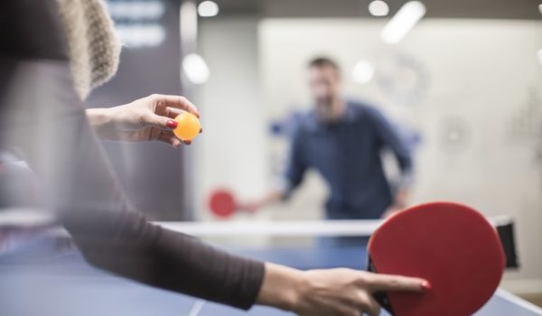 two-colleagues-playing-table-tennis-in-office-break-room-673117017-592611993df78cbe7e959740